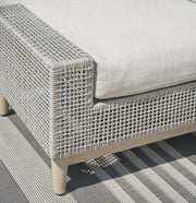 Seton Creek outdoor seating set by Ashley Furniture featuring a patio table and cushioned chairs in a stylish garden setting.