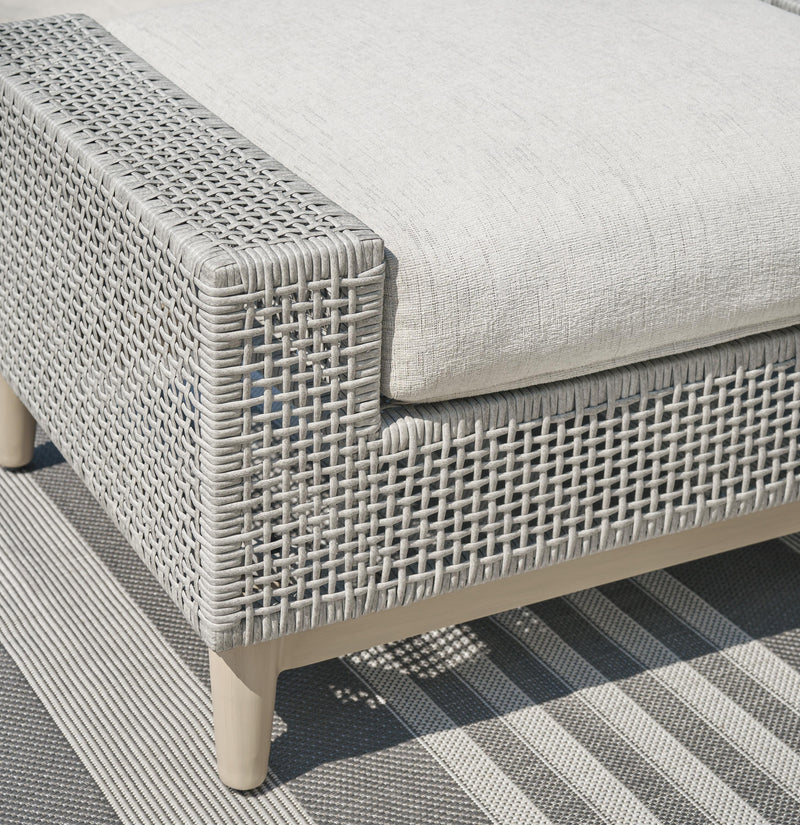 Seton Creek outdoor seating set by Ashley Furniture featuring a patio table and cushioned chairs in a stylish garden setting.