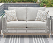 Seton Creek outdoor seating set by Ashley Furniture with cushioned chairs and a matching table, ideal for patio relaxation.