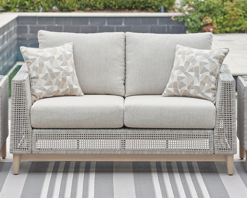 Seton Creek outdoor seating set by Ashley Furniture with cushioned chairs and a matching table, ideal for patio relaxation.