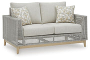 Ashley Furniture Seton Creek outdoor seating set with cushioned chairs and a matching table for patio relaxation.
