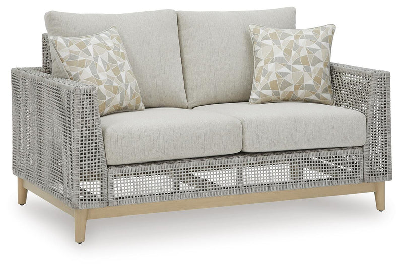Ashley Furniture Seton Creek outdoor seating set with cushioned chairs and a matching table for patio relaxation.