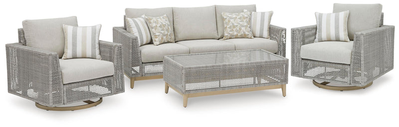 Ashley Furniture Seton Creek outdoor upholstery set with matching outdoor table and cushioned chairs in a garden setting