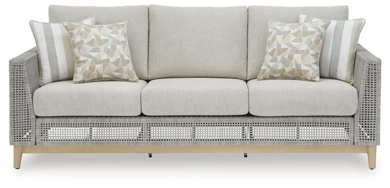Seton Creek outdoor seating set by Ashley Furniture with cushioned chairs and a matching table in a patio setting.