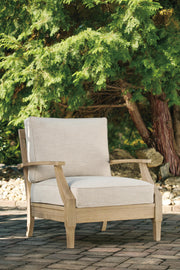 Ashley Furniture Clare View outdoor seating set with cushioned chairs and a matching table in a stylish patio arrangement.