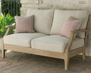 Outdoor loveseat by Ashley Furniture with cushion, featuring a cozy seating area and stylish design for outdoor relaxation.