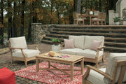 Outdoor Ashley Furniture Clare View loveseat with cushion, featuring a cozy seating area and stylish design.