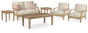 Ashley Furniture Clare View outdoor seating set with cushioned chairs and a matching table in a backyard setting.