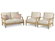 Ashley Furniture Clare View outdoor seating set with cushioned chairs and a table, perfect for patio relaxation.