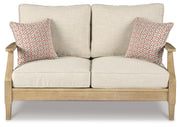 Ashley Furniture Clare View outdoor loveseat with cushion, featuring a cozy seating area and stylish design for outdoor relaxation.