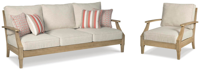 Ashley Furniture Clare View outdoor seating set with cushioned chairs and a matching table, ideal for patio relaxation.