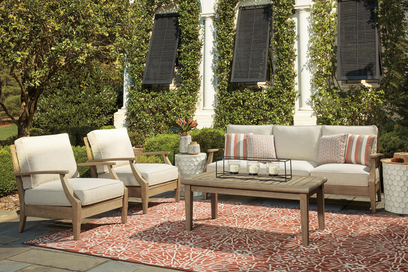 Ashley Furniture Clare View outdoor seating set with cushioned chairs and a matching table, perfect for patio relaxation.