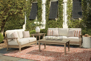 Ashley Furniture Clare View outdoor seating set with cushioned chairs and matching table, ideal for patio relaxation.