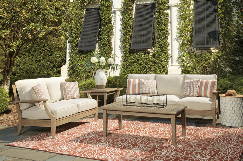 Ashley Furniture Clare View outdoor seating set with cushioned chairs and matching table, ideal for patio relaxation.