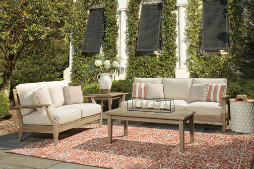 Ashley Furniture Clare View outdoor seating set with cushioned chairs and matching table, ideal for patio relaxation.