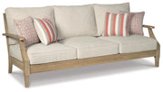 Ashley Furniture Clare View outdoor sofa with cushions, featuring a stylish frame and comfortable seating for outdoor relaxation.
