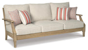 Ashley Furniture Clare View outdoor seating set with cushioned chairs and a matching table, shown from an angled view.