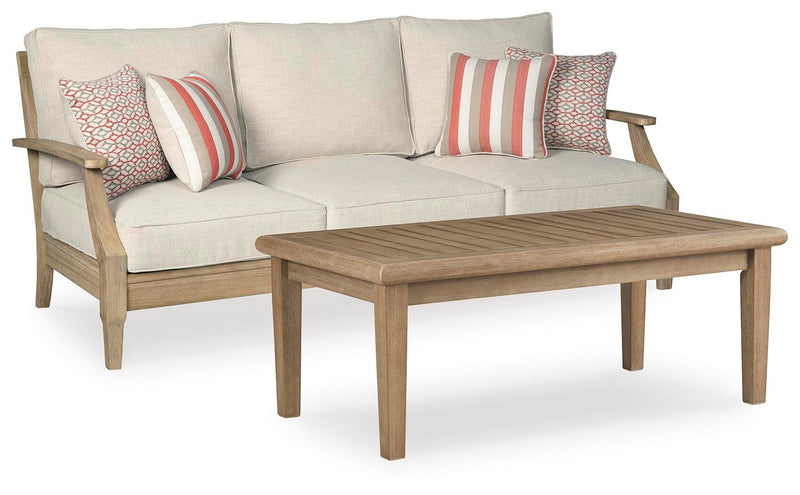 Outdoor seating set by Ashley Furniture with cushioned chairs and a matching table in a cozy patio setting.