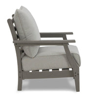 Ashley Furniture Visola outdoor sofa and loveseat set with matching table, featuring cushioned seating and stylish metal frame.