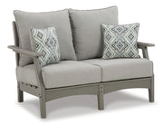 Ashley Furniture Visola outdoor sofa and loveseat set with a matching table, featuring cushioned seating and a stylish outdoor table.