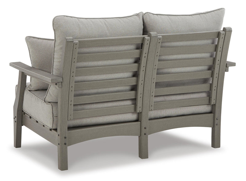 Ashley Furniture Visola outdoor sofa and loveseat set with matching table, featuring cushioned seating and stylish design.