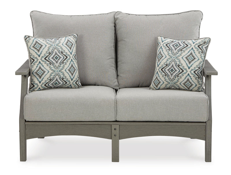Ashley Furniture Visola outdoor sofa and loveseat set with matching table, featuring cushioned seats and a stylish outdoor design.