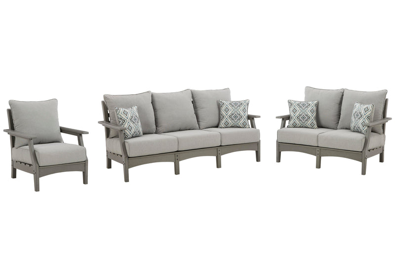 Ashley Furniture Visola outdoor seating set with cushioned chairs and table, perfect for patio relaxation.