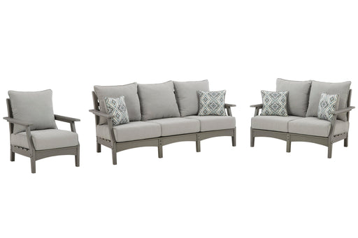 Ashley Furniture Visola outdoor seating set with cushioned chairs and table, perfect for patio relaxation.