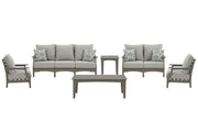 Ashley Furniture Visola outdoor sofa and loveseat set with matching table, featuring woven rattan-style frames and plush cushions.