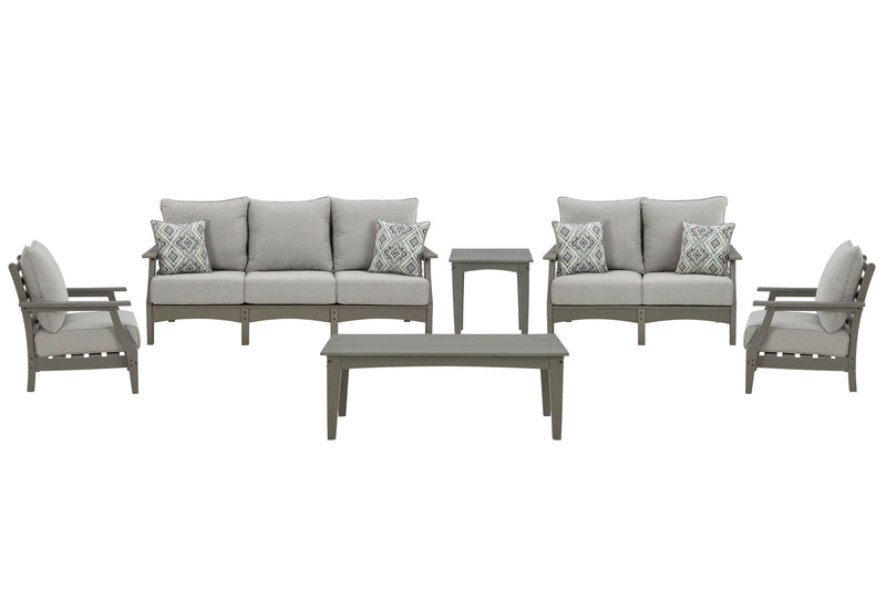Ashley Furniture Visola outdoor sofa and loveseat set with matching table, featuring woven rattan-style frames and plush cushions.