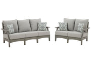 Ashley Furniture Visola outdoor seating set with cushioned chairs and table, perfect for patio relaxation.