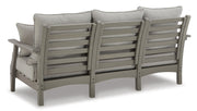 Ashley Furniture Visola outdoor sofa and loveseat set with matching outdoor table, featuring cushioned seats and stylish design.