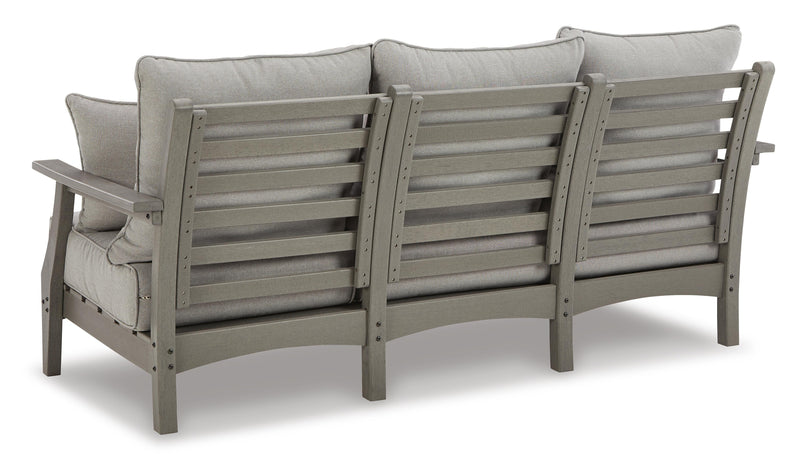Ashley Furniture Visola outdoor sofa and loveseat set with matching outdoor table, featuring cushioned seats and stylish design.