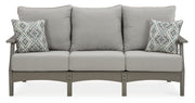 Ashley Furniture Visola outdoor sofa and loveseat set with matching table, featuring comfortable cushions and modern outdoor design.