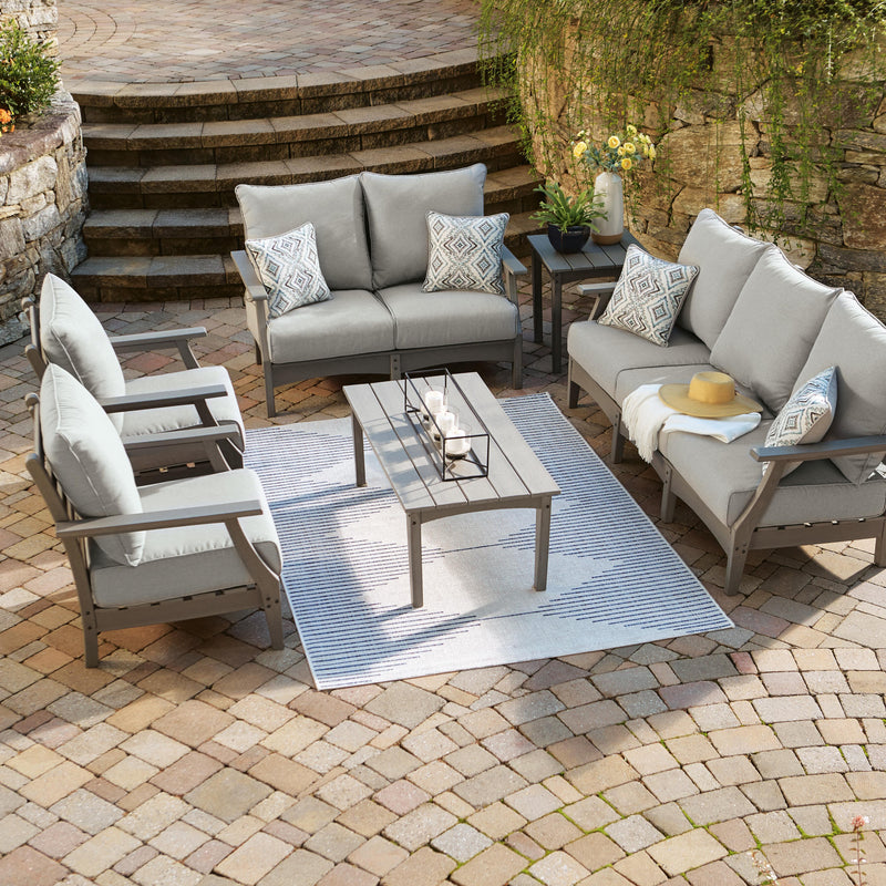 Ashley Furniture Visola outdoor sofa and loveseat set with a matching table, featuring cushioned seating and stylish design for outdoor use.