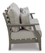 Ashley Furniture Visola outdoor sofa and loveseat set with matching outdoor table, featuring comfortable cushions and stylish design.