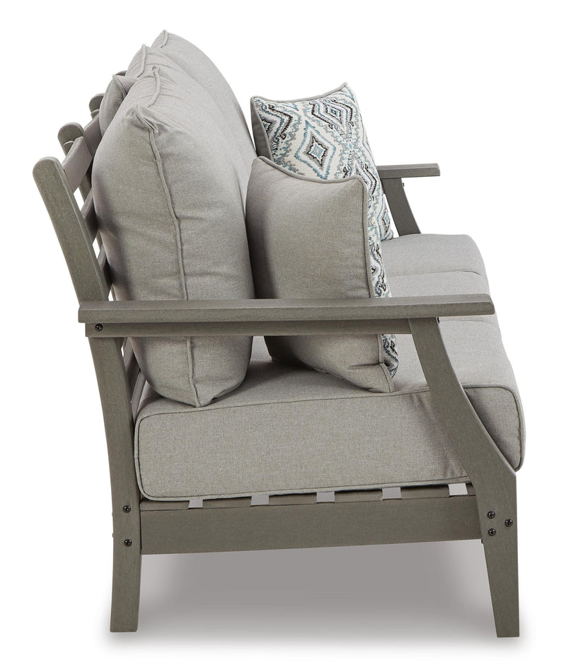 Ashley Furniture Visola outdoor sofa and loveseat set with matching outdoor table, featuring comfortable cushions and stylish design.