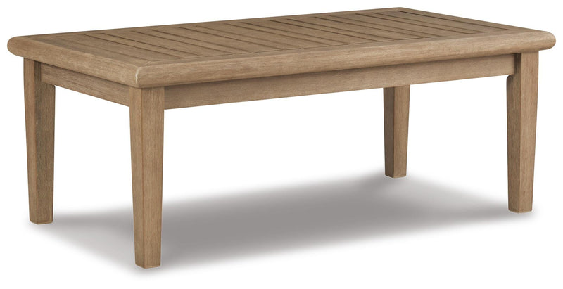 Outdoor Ashley Furniture Clare View outdoor seating set with cushioned chairs and table, shown from an angle in a garden setting.