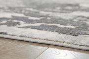 Close-up of Ashley Furniture Mazatl 7'10" x 10'2" rug showing intricate woven pattern and soft texture in neutral tones.