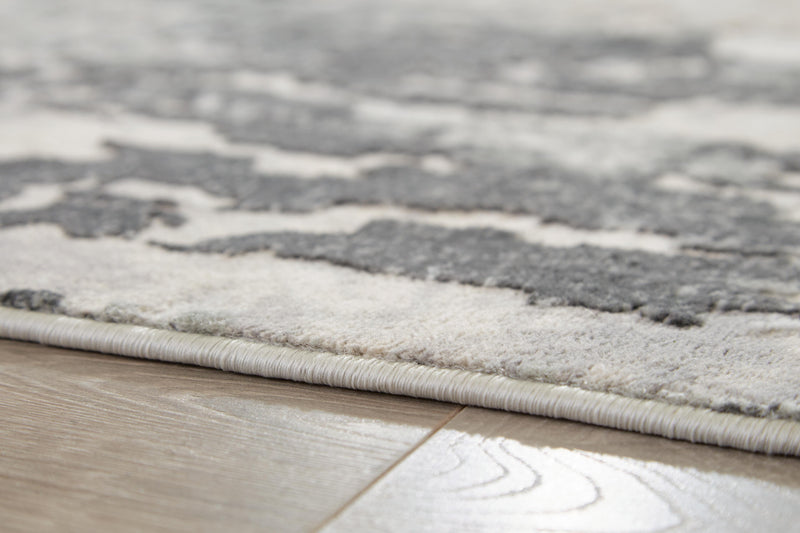 Close-up of Ashley Furniture Mazatl rug showing intricate patterns and soft texture in a 5'3" x 7'3" size.
