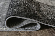 Medium Ashley Furniture Brycebourne 5'3" x 7'7" rug with intricate pattern and soft texture, shown in detailed roll image.