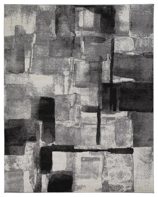 Medium Ashley Furniture Brycebourne 5'3" x 7'7" rug with intricate patterns and soft texture, shown in a cozy living room setting.