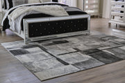 Medium Ashley Furniture Brycebourne 5'3" x 7'7" rug with intricate pattern and soft texture, perfect for living room decor.