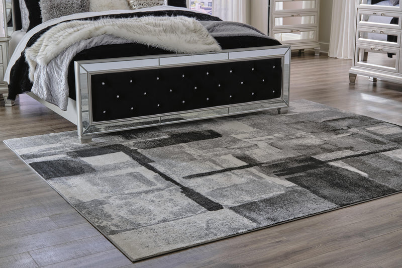 Medium Ashley Furniture Brycebourne 5'3" x 7'7" rug with intricate pattern and soft texture, perfect for living room decor.
