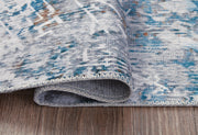 Medium Ashley Furniture washable rug, 5' x 7' size, featuring detailed patterns in neutral tones.
