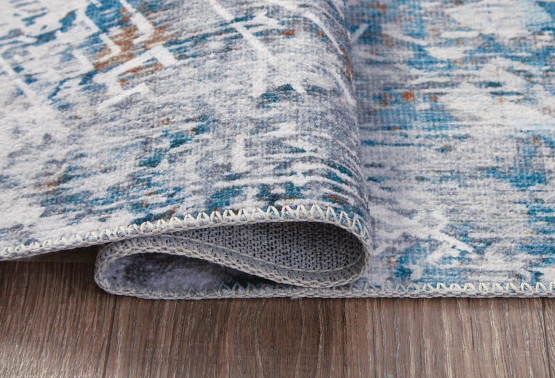 Medium Ashley Furniture washable rug, 5' x 7' size, featuring detailed patterns in neutral tones.
