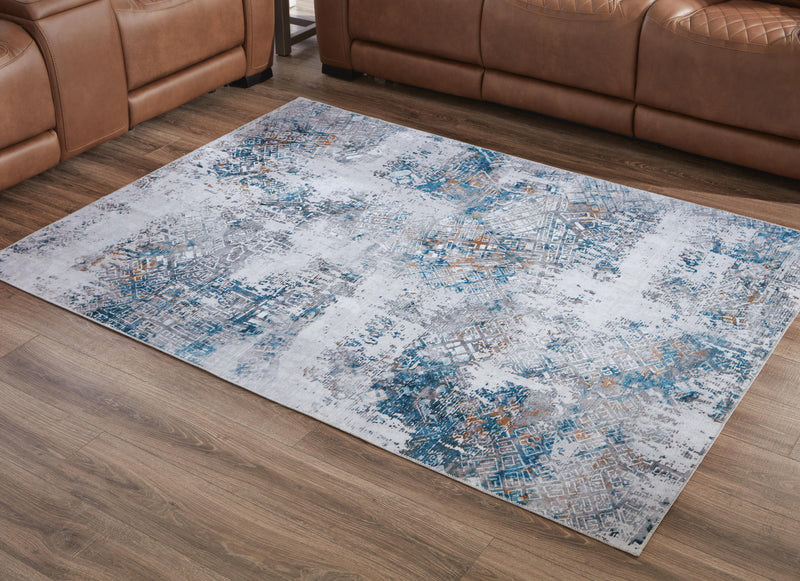 Medium Ashley Furniture Garyard 5' x 7' washable rug with a patterned design, ideal for living rooms or bedrooms.