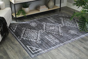 Ashley Furniture Arloman Rug with intricate patterns and warm tones, suitable for living rooms and bedrooms.