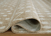 Large washable rug by Ashley Furniture, 7'10" x 10'3" in neutral tones, featuring a soft, textured surface with detailed stitching.