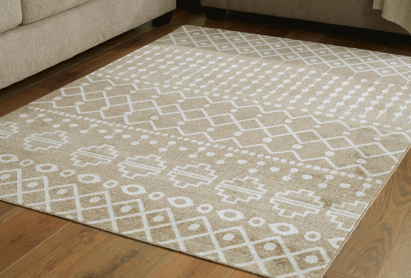 Medium washable rug by Ashley Furniture, 4'11" x 7'2", featuring a soft, textured pattern in neutral tones.